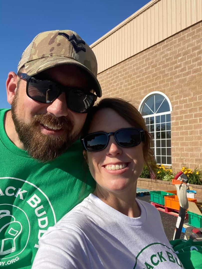 Jacque and her husband pose for a photo