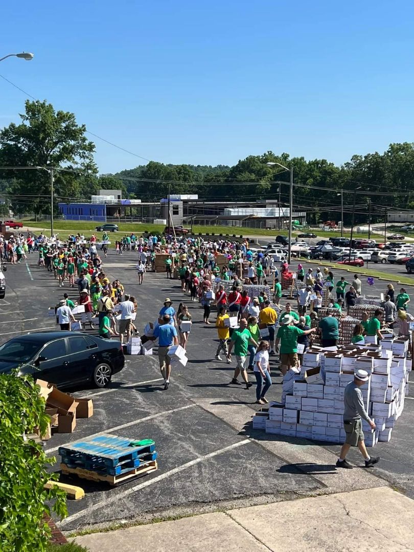 Several dozen volunteers spent the day in a large parking lot packing boxes