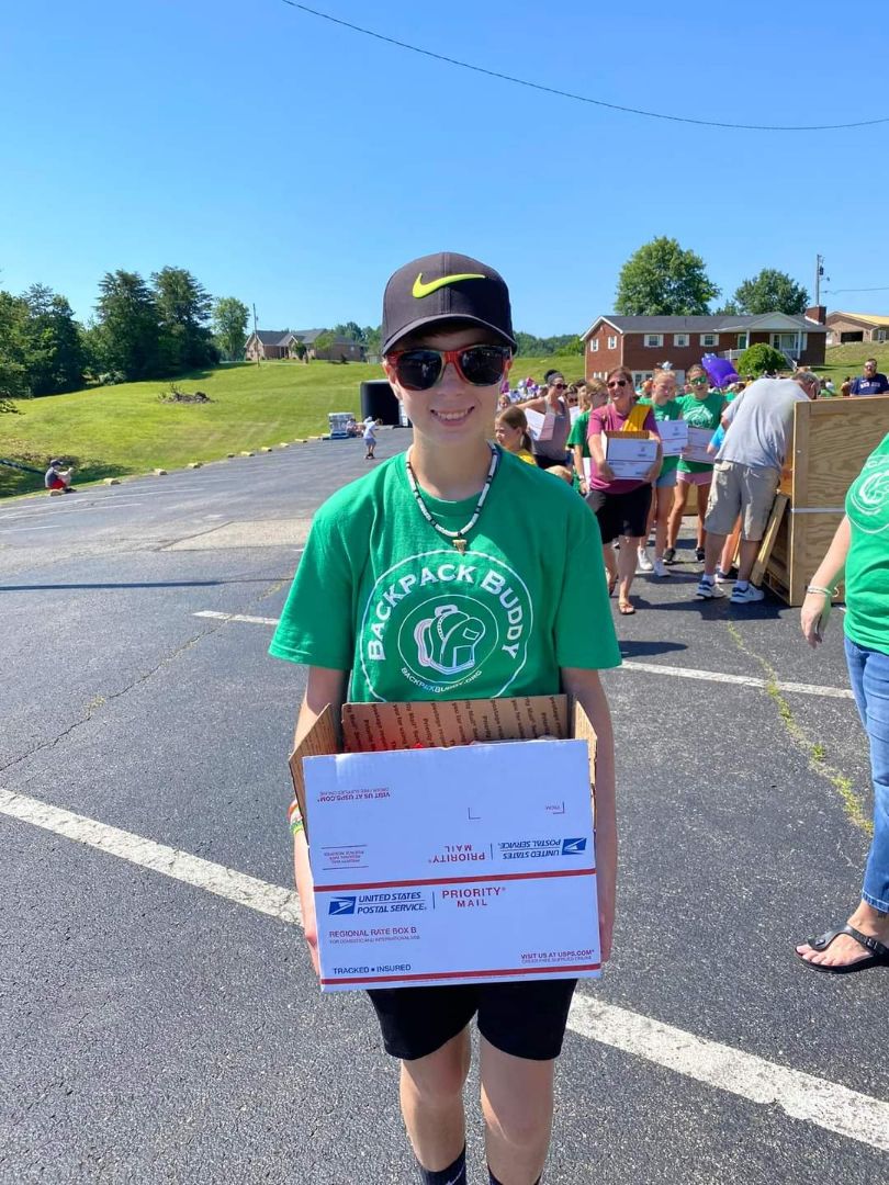 Jacque's daughter carrying a box